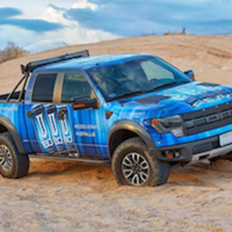 Full-color vehicle graphics applied to car side panels for branded fleet marketing