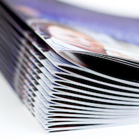 Open and closed custom-printed booklets showcasing full-color pages