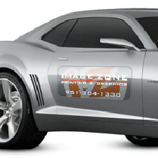 Custom magnetic sign attached to vehicle door for temporary business advertising